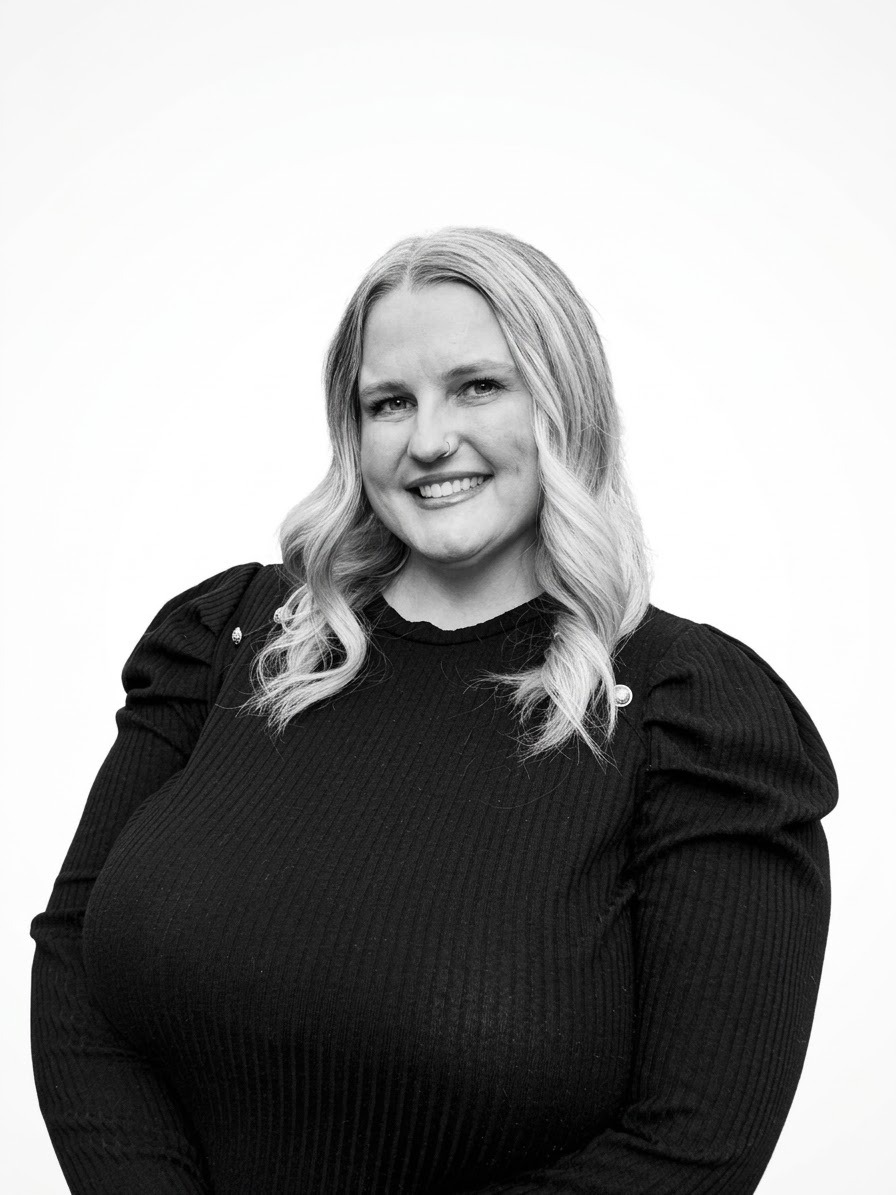Jenna, Daily Operations Manager, smiling in a staff portrait