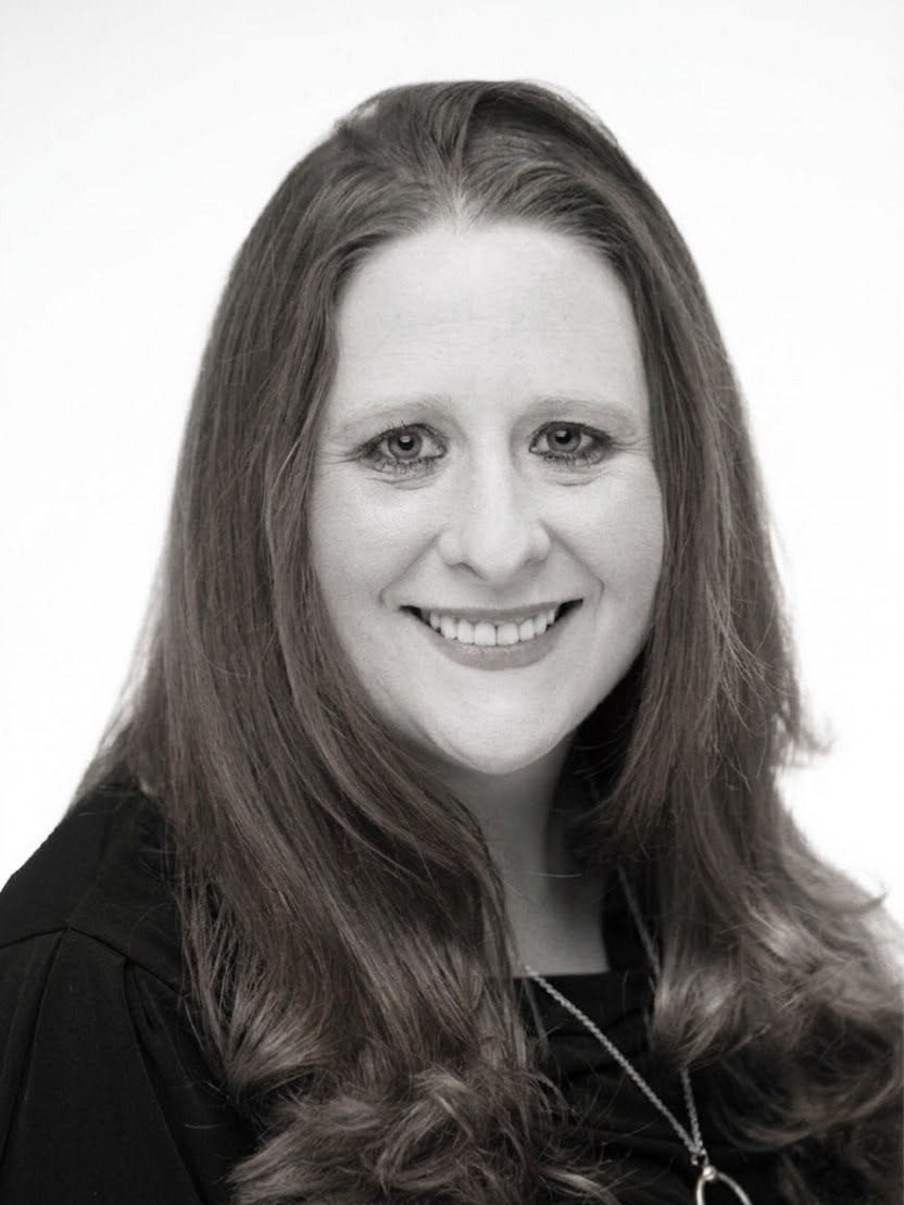 Sarah, Business Operations Manager, smiling in a staff portrait